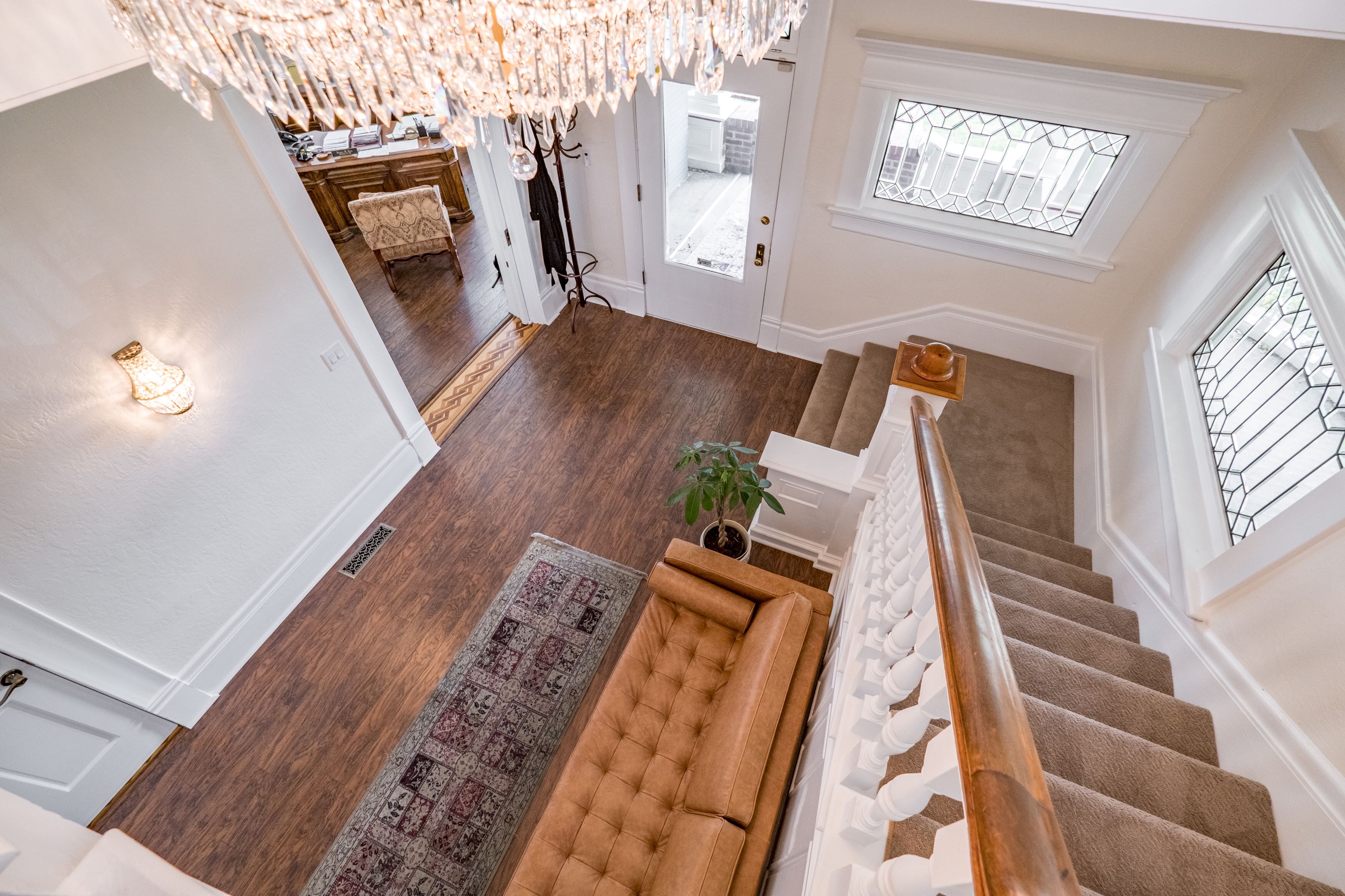 Inside the Hess and Associates office. Crystal chandelier, hardwood floors, leather seating, and leaded glass windows in the 1905 Twaddle Mansion